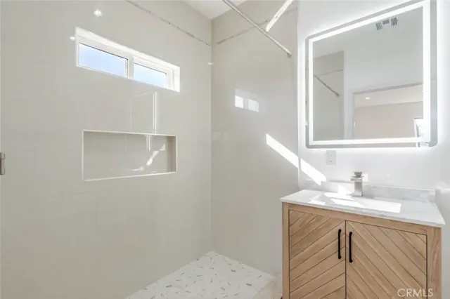 a bathroom with a sink a vanity and a mirror