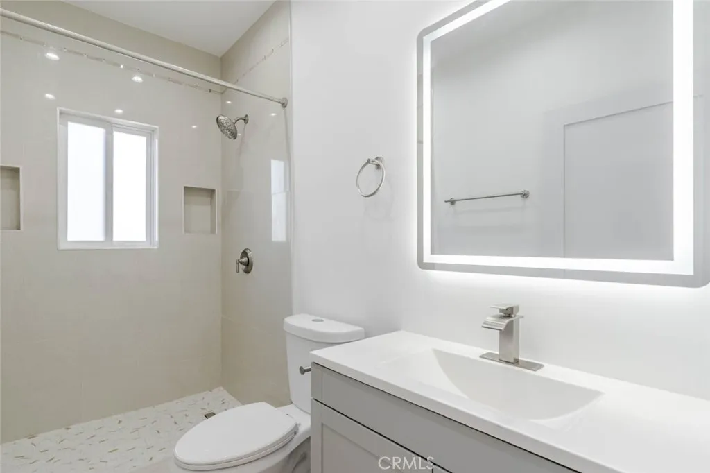 6850 Ranchito Avenue Van Nuys, CA 91405 - Photo 21 of 23 a bathroom with a sink toilet vanity and shower