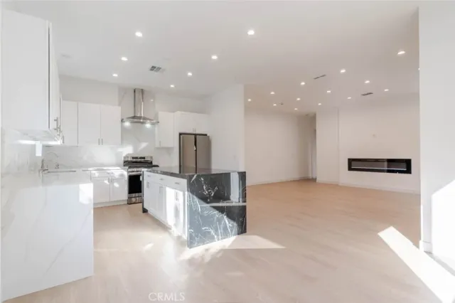 a view of kitchen with refrigerator microwave and stove