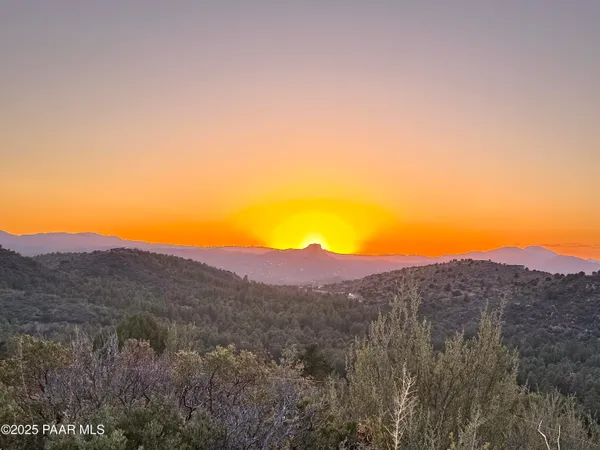 a view of a large mountain with a grassy field
