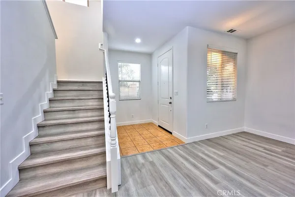 a view of wooden floor and windows in a room