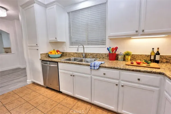 a kitchen with white cabinets and a sink