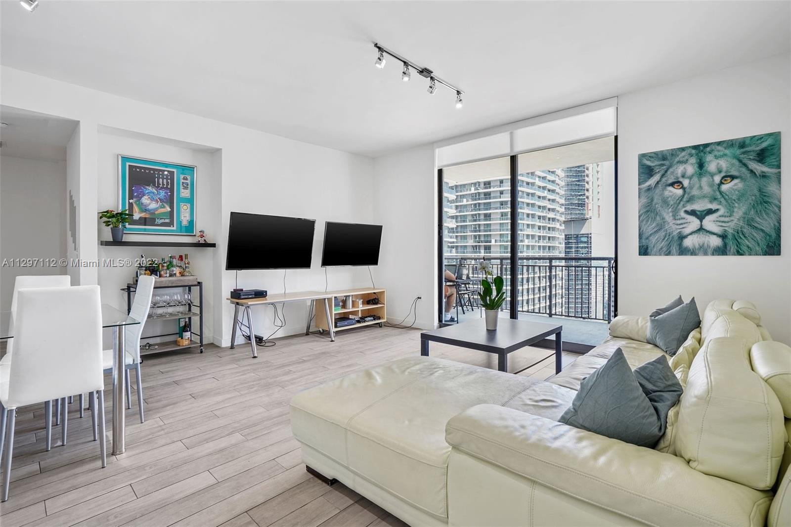 999 Southwest 1st Avenue, Unit 2717 Miami, FL 33130 - Photo 1 of 93 a living room with furniture and a flat screen tv