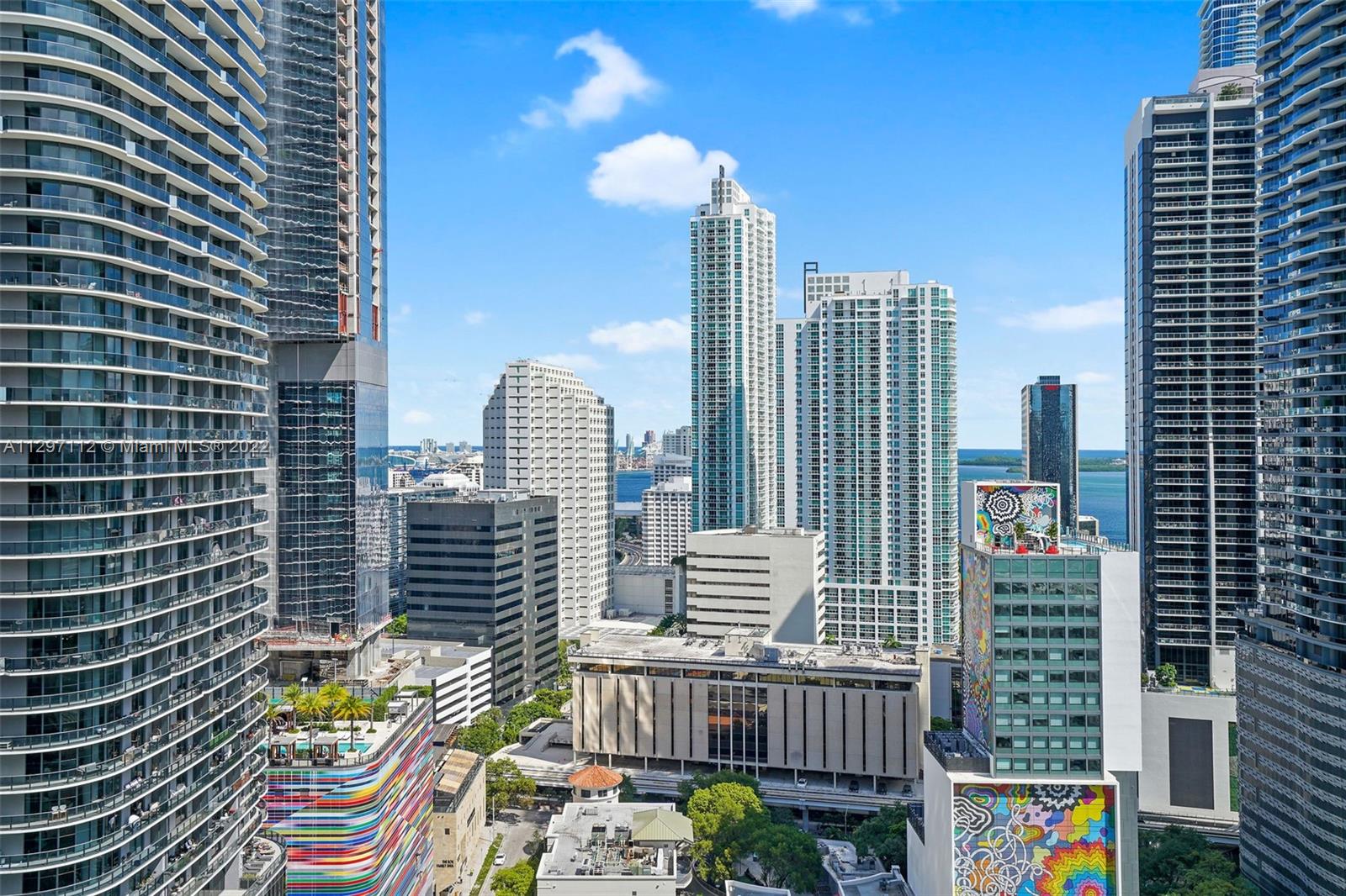 999 Southwest 1st Avenue, Unit 2717 Miami, FL 33130 - Photo 12 of 93 a view of balcony with wooden floor and outdoor seating