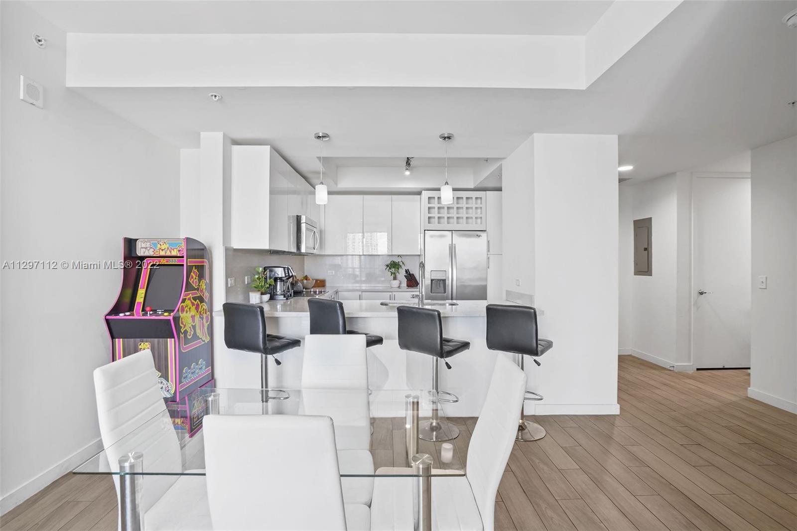 999 Southwest 1st Avenue, Unit 2717 Miami, FL 33130 - Photo 14 of 93 a view of a dining room with furniture and wooden floor