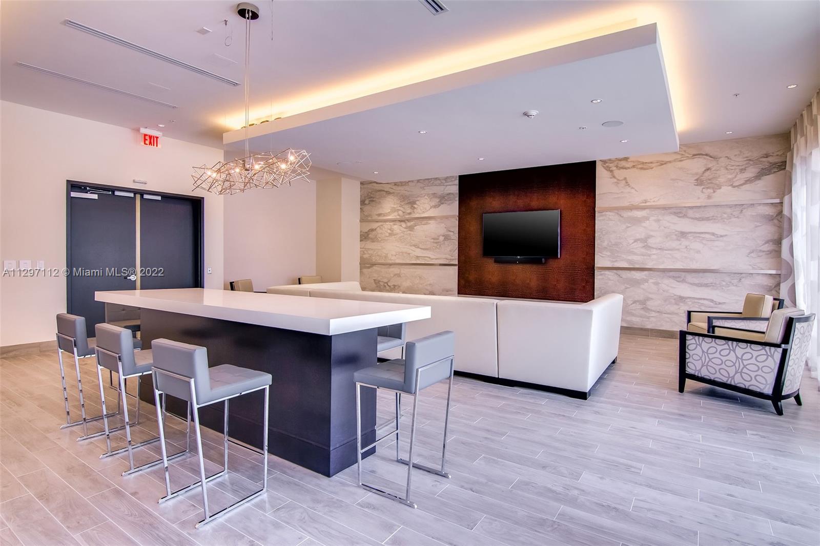 999 Southwest 1st Avenue, Unit 2717 Miami, FL 33130 - Photo 28 of 93 a kitchen with a table and chairs in it