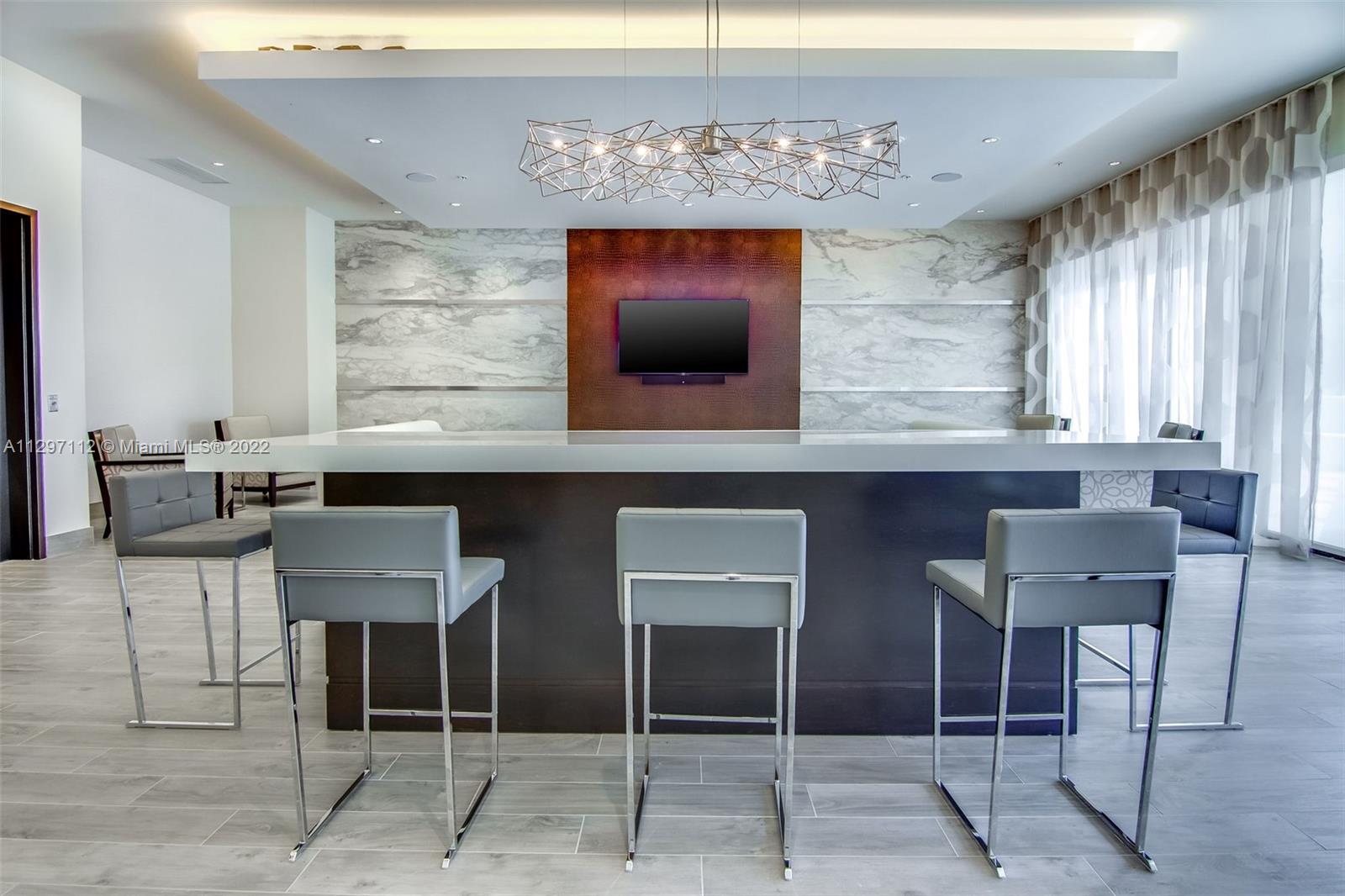 999 Southwest 1st Avenue, Unit 2717 Miami, FL 33130 - Photo 33 of 93 a kitchen with a table and chairs in it