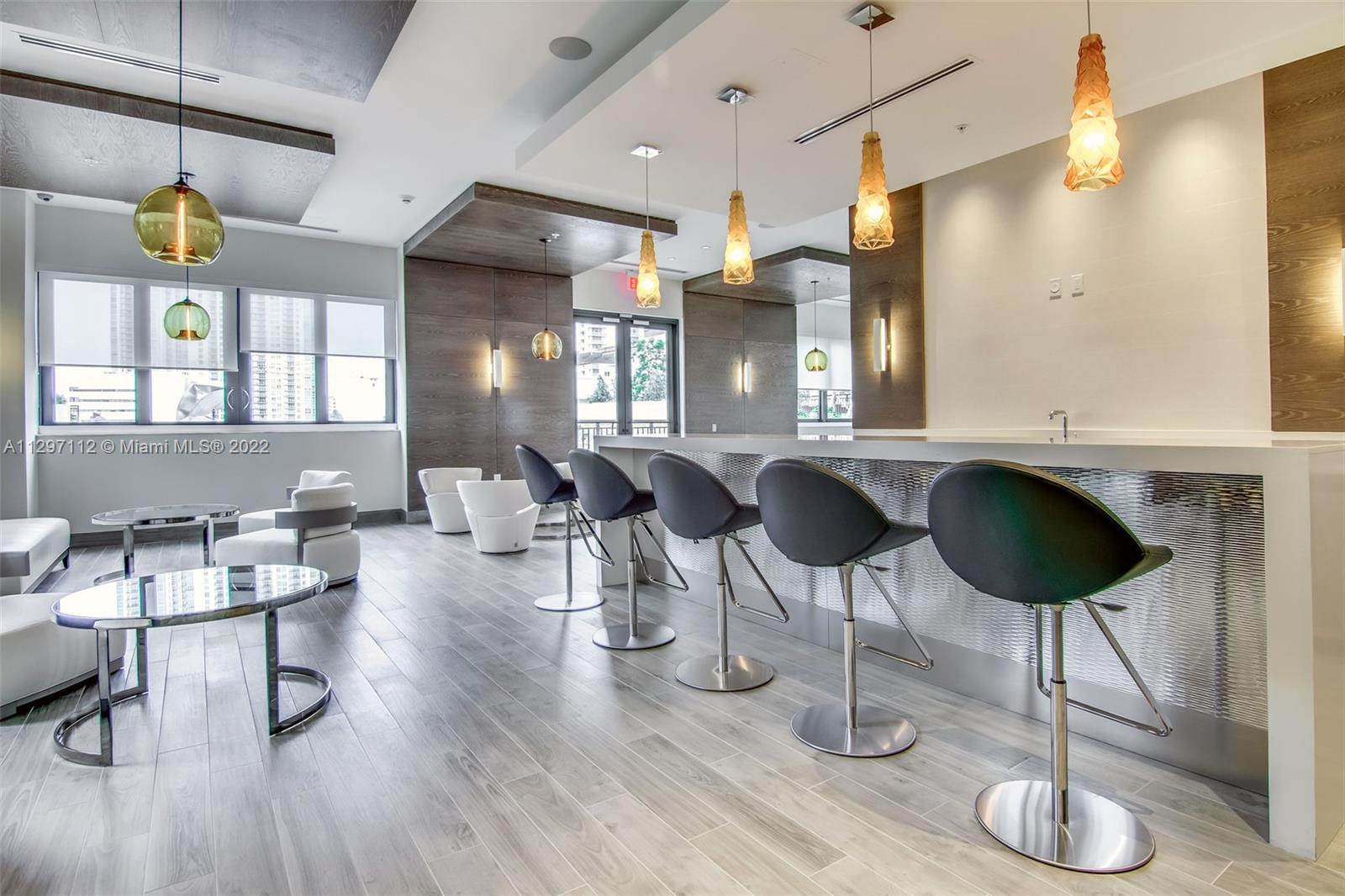 999 Southwest 1st Avenue, Unit 2717 Miami, FL 33130 - Photo 61 of 93 a view of a kitchen and dining area with chandelier