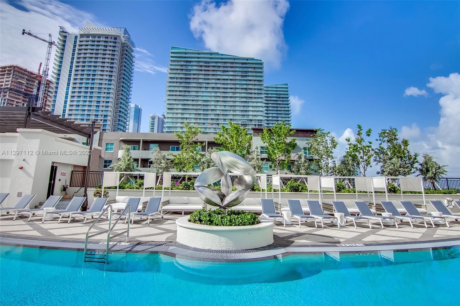 999 Southwest 1st Avenue, Unit 2717 Miami, FL 33130 - Photo 63 of 93 a view of a swimming pool with outdoor seating