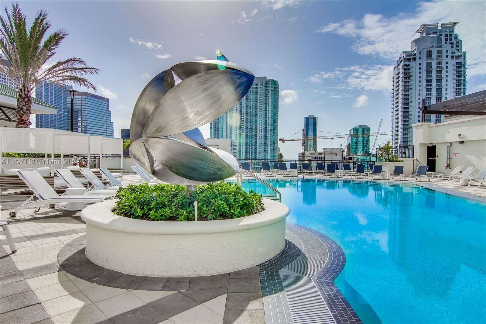 999 Southwest 1st Avenue, Unit 2717 Miami, FL 33130 - Photo 66 of 93 a view of a swimming pool in the backyard of a house