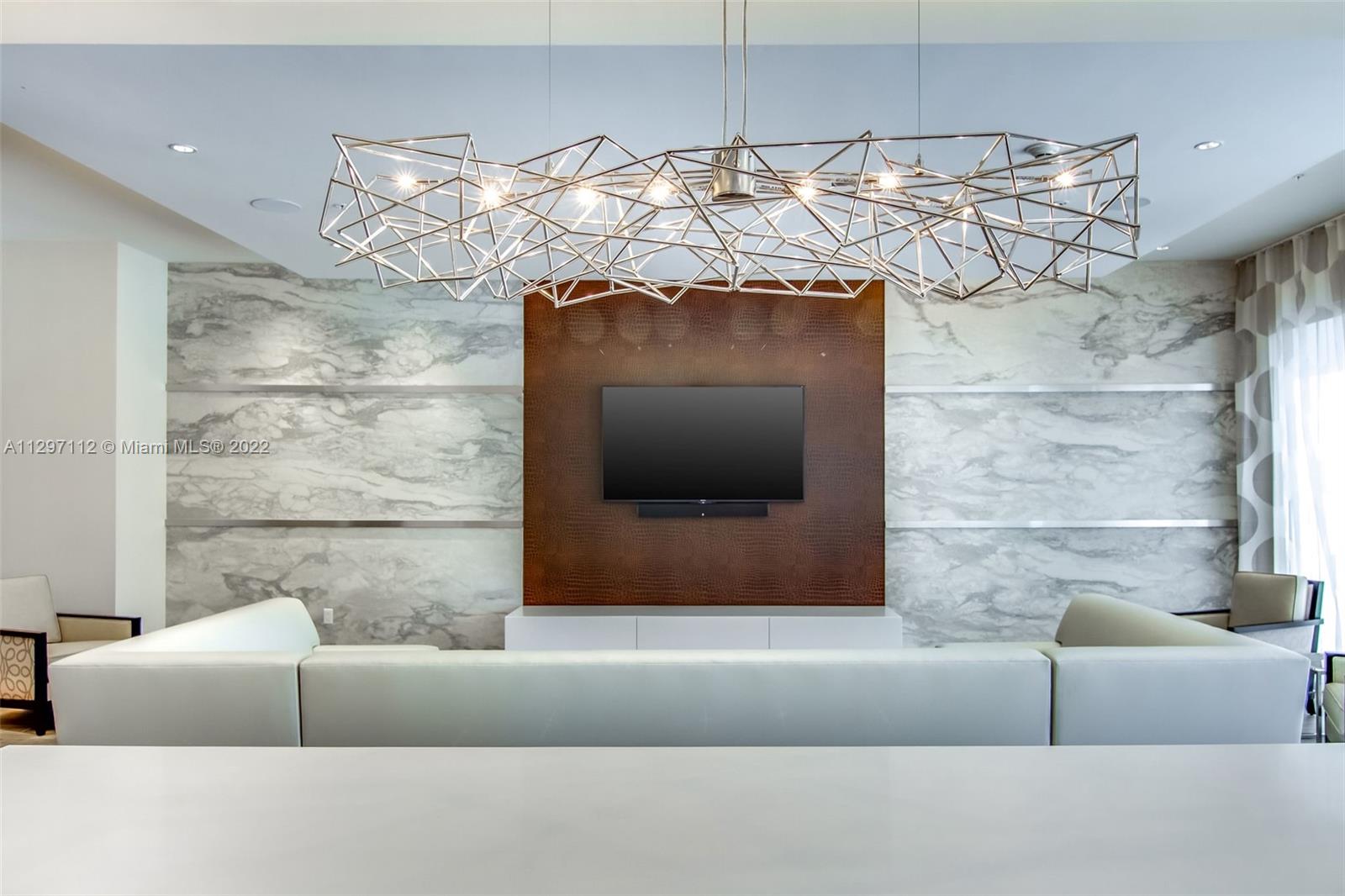 999 Southwest 1st Avenue, Unit 2717 Miami, FL 33130 - Photo 69 of 93 a living room with a couch and a fireplace