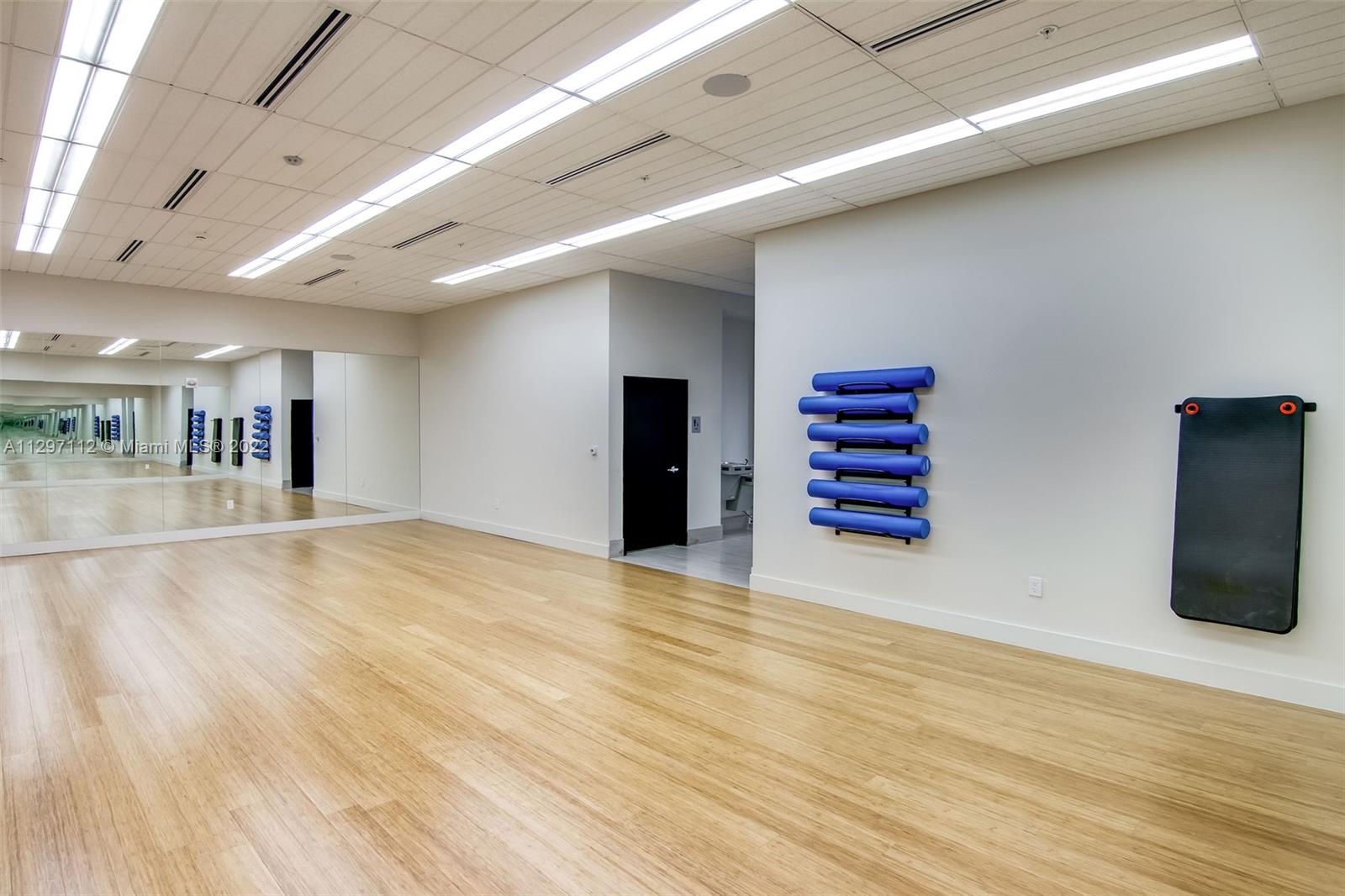 999 Southwest 1st Avenue, Unit 2717 Miami, FL 33130 - Photo 85 of 93 a view of an empty room with wooden floor and a window