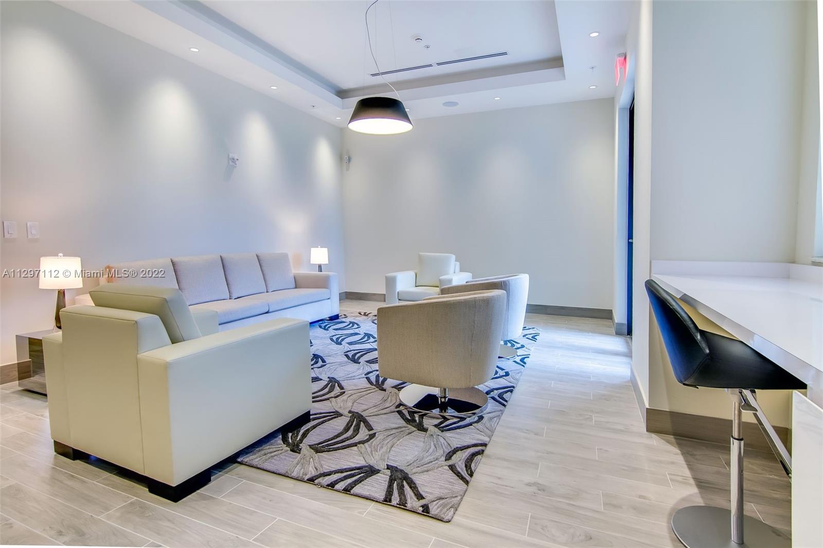 999 Southwest 1st Avenue, Unit 2717 Miami, FL 33130 - Photo 91 of 93 a living room with a couch and a table