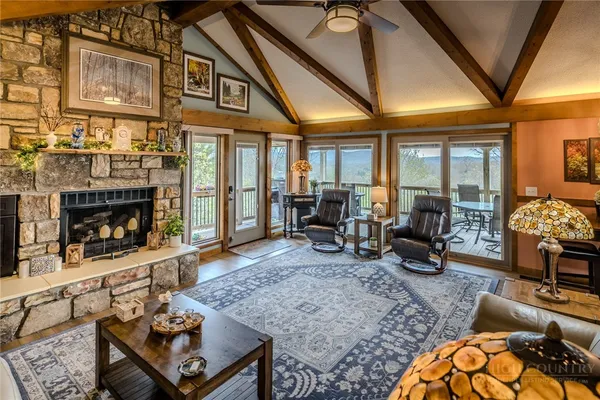 a living room with furniture rug and a fireplace