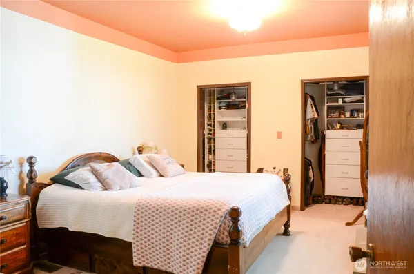 a bedroom with bed and wooden floor