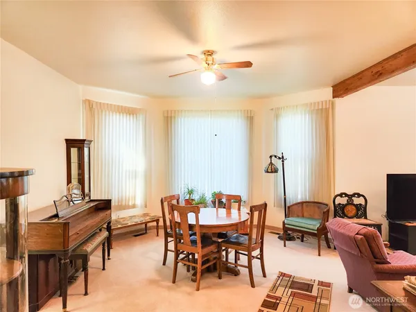 a view of a livingroom with furniture and a window