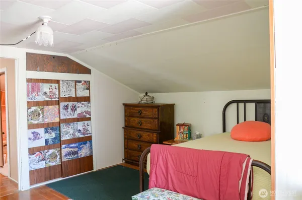 a bedroom with a bed and dresser