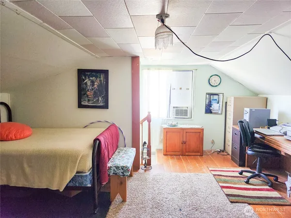 a bedroom with furniture and a wooden floor