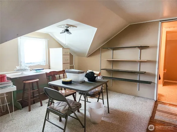 a view of a dining room with furniture and window