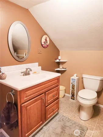 a bathroom with a sink mirror vanity and toilet
