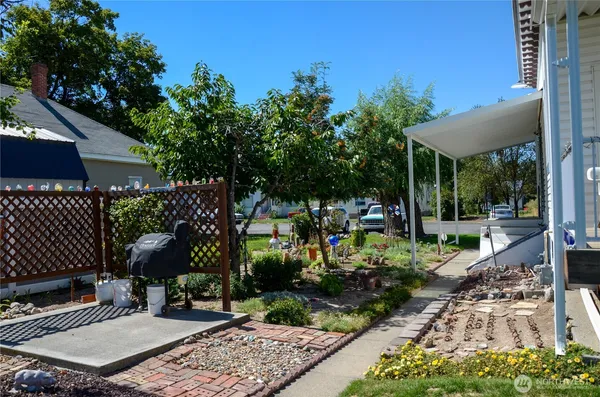 a view of a table and chairs in backyard of the house