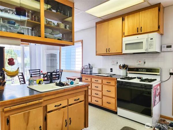 a kitchen with stainless steel appliances a stove a sink and a microwave