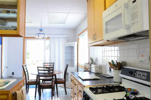 a kitchen with a stove a sink and a refrigerator