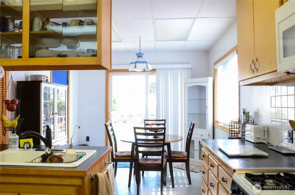a kitchen with a table chairs and a stove