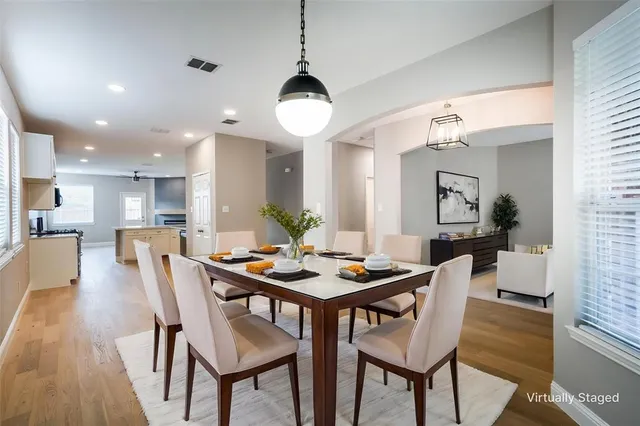 a view of a dining room with furniture and wooden floor
