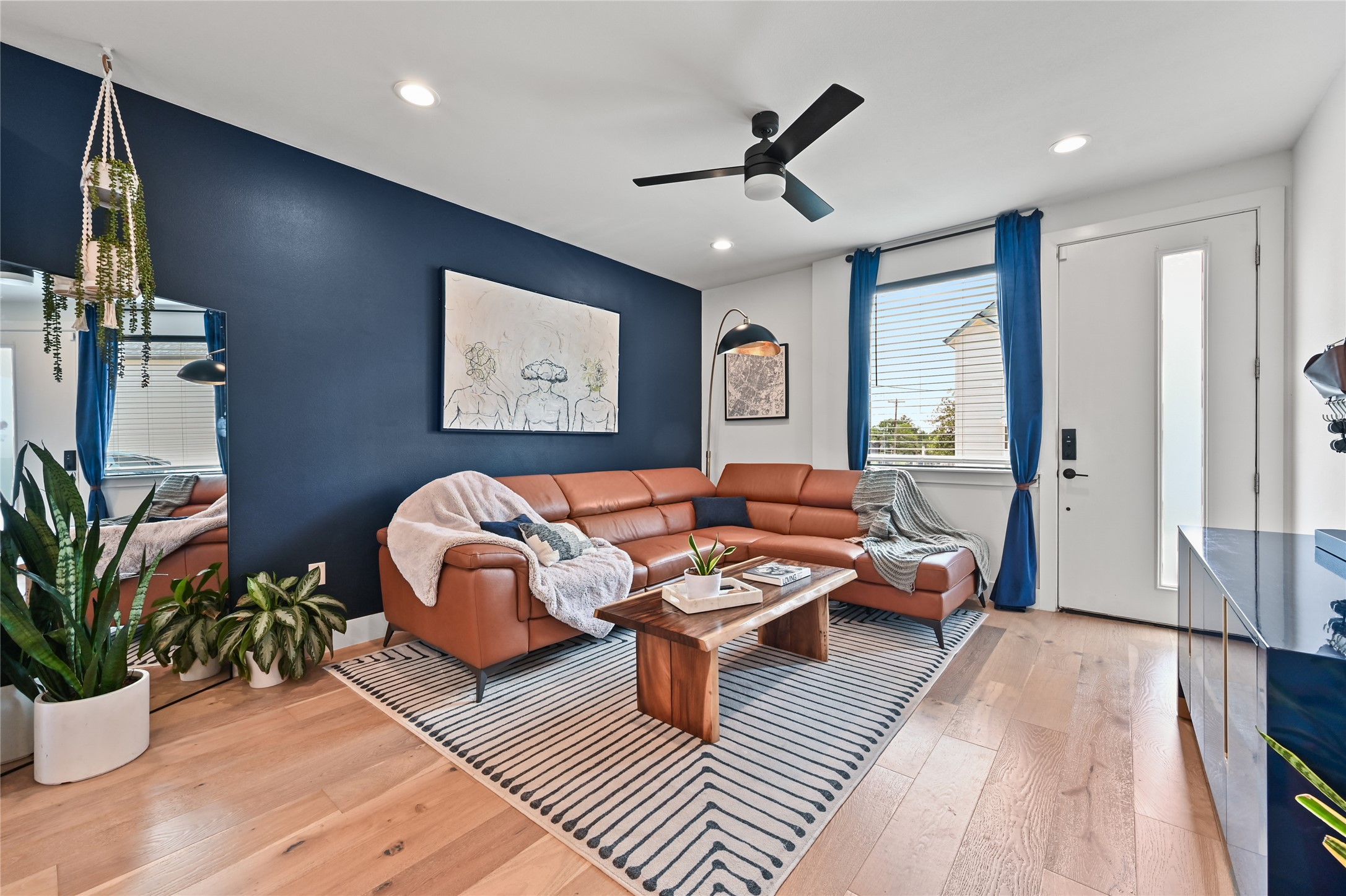 Living room with hardwood / wood-style floors, ceiling fan, and recessed lighting