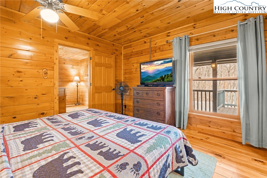 1748 Junaluska Road Boone, NC 28607 - Photo 12 of 37 a bedroom with a bed and a flat screen tv