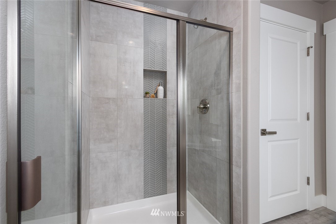 6515 Southeast 2nd Place Renton, WA 98059 - Photo 14 of 29 a bathroom with a glass shower door