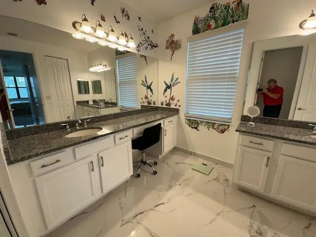 a spacious bathroom with a sink and a mirror