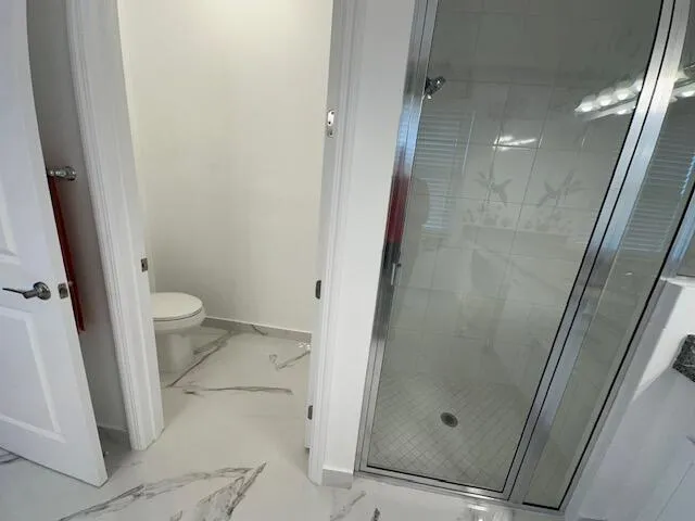 a bathroom with a glass door shower