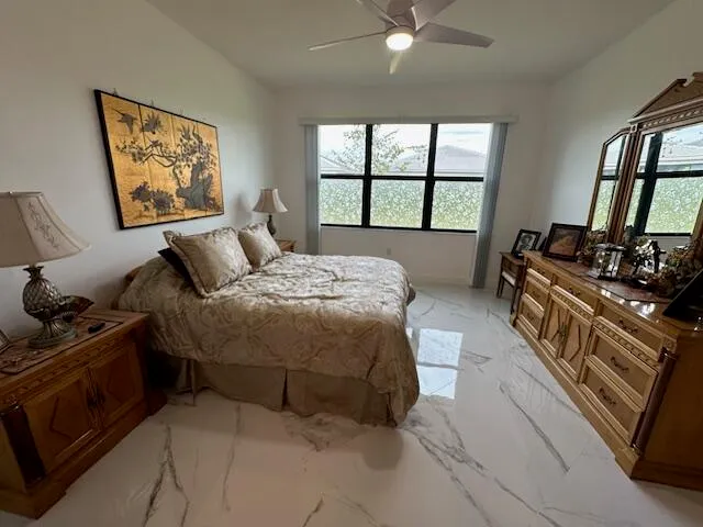 a spacious bedroom with a bed and a window