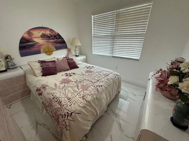 a bedroom with a bed and a large mirror
