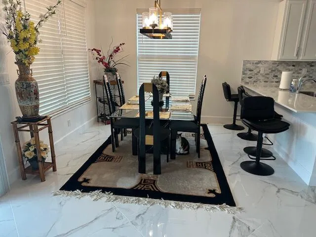 a dining room with furniture and wooden floor