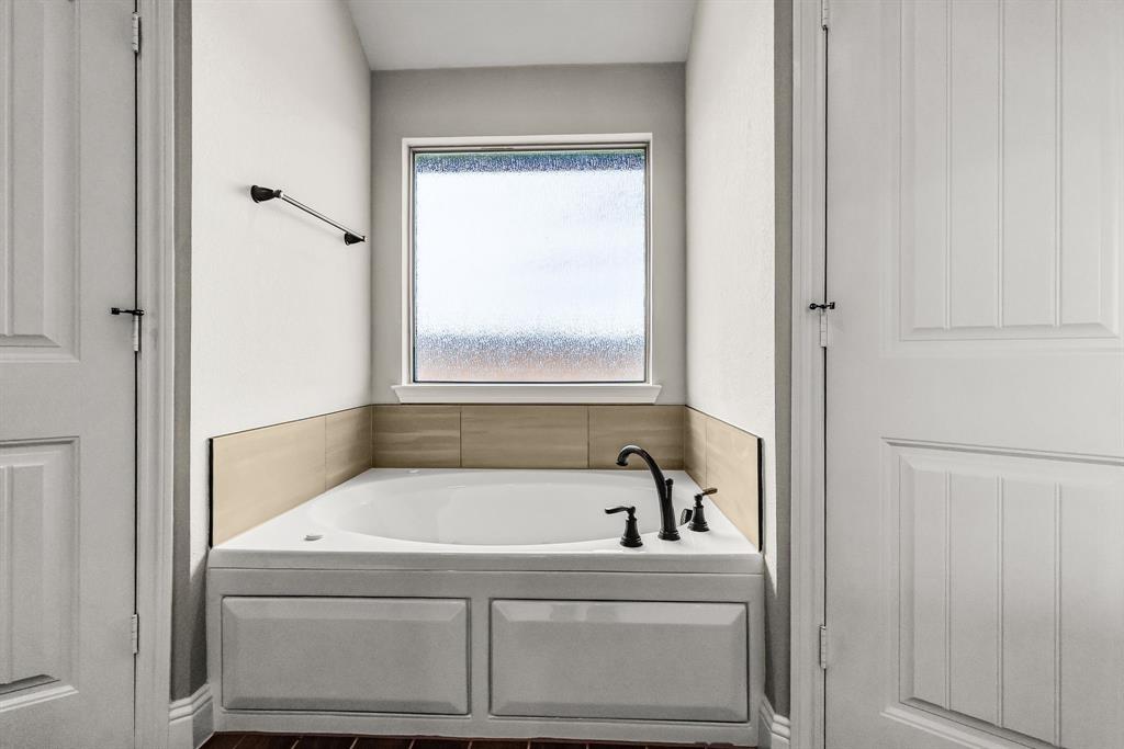 314 Pennington Road Josephine, TX 75173 - Photo 16 of 37 a white bath tub sitting next to a window