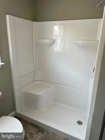 a bathroom with a shower and toilet