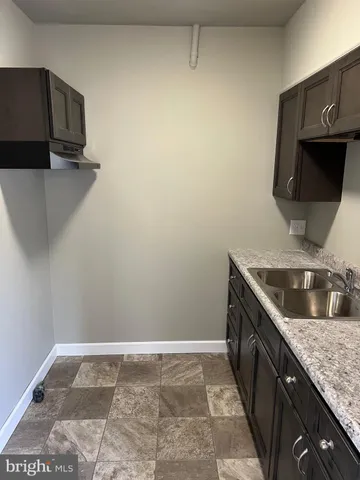 a kitchen with stainless steel appliances granite countertop a sink and a stove