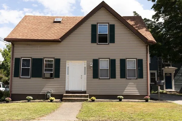 a front view of a house with a yard