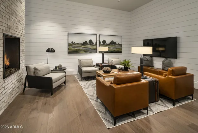 a bedroom with a bed and a chair in it