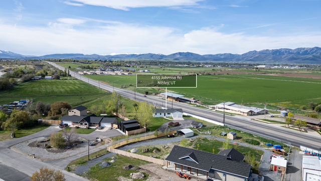 4155 Johnson Road Nibley, UT 84321 - Photo 62 of 71 Aerial view of sparsely populated area featuring mountains and nearby suburban area
