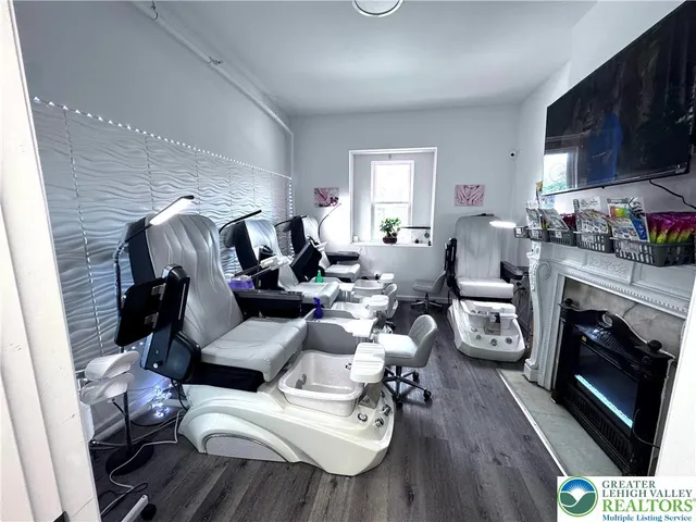 a living room with furniture fireplace and flat screen tv