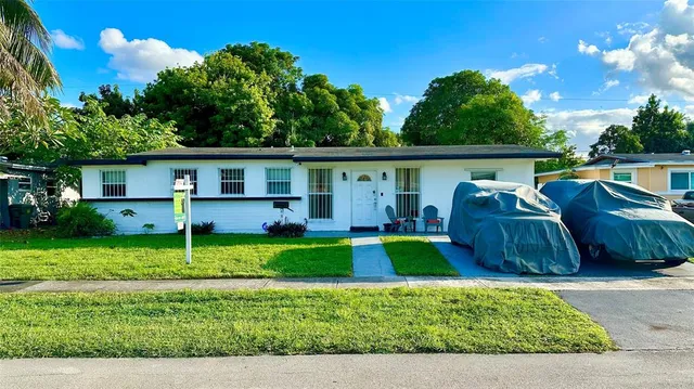 a view of backyard with deck and outdoor seating