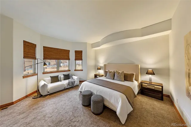 a spacious bedroom with a bed and a couch