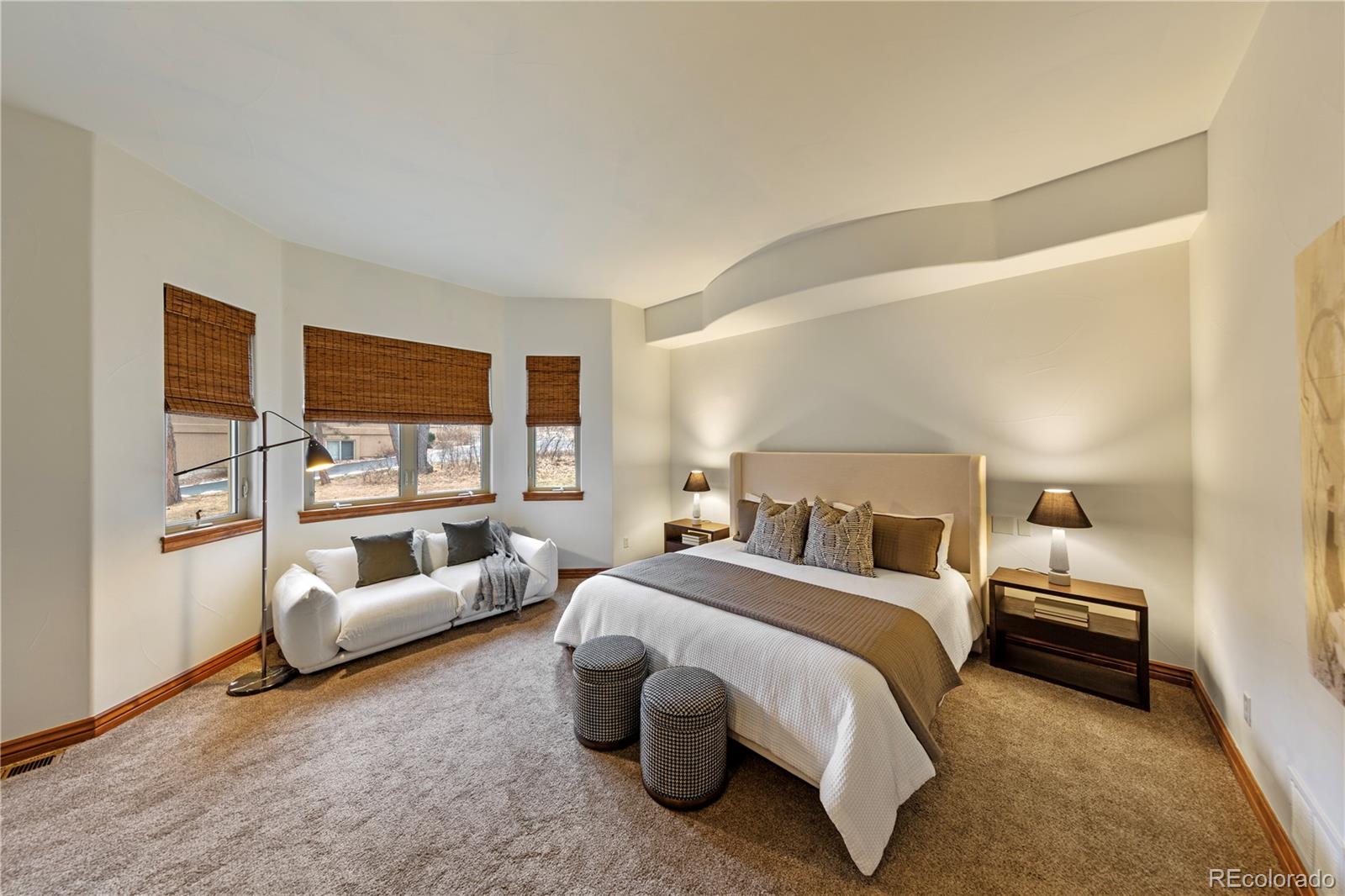 590 Cumberland Road Larkspur, CO 80118 - Photo 13 of 47 a spacious bedroom with a bed and a couch