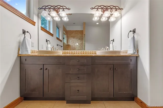 a bathroom with a sink vanity and a mirror