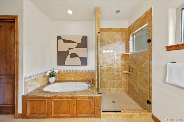 a bathroom with a granite countertop sink a mirror and shower