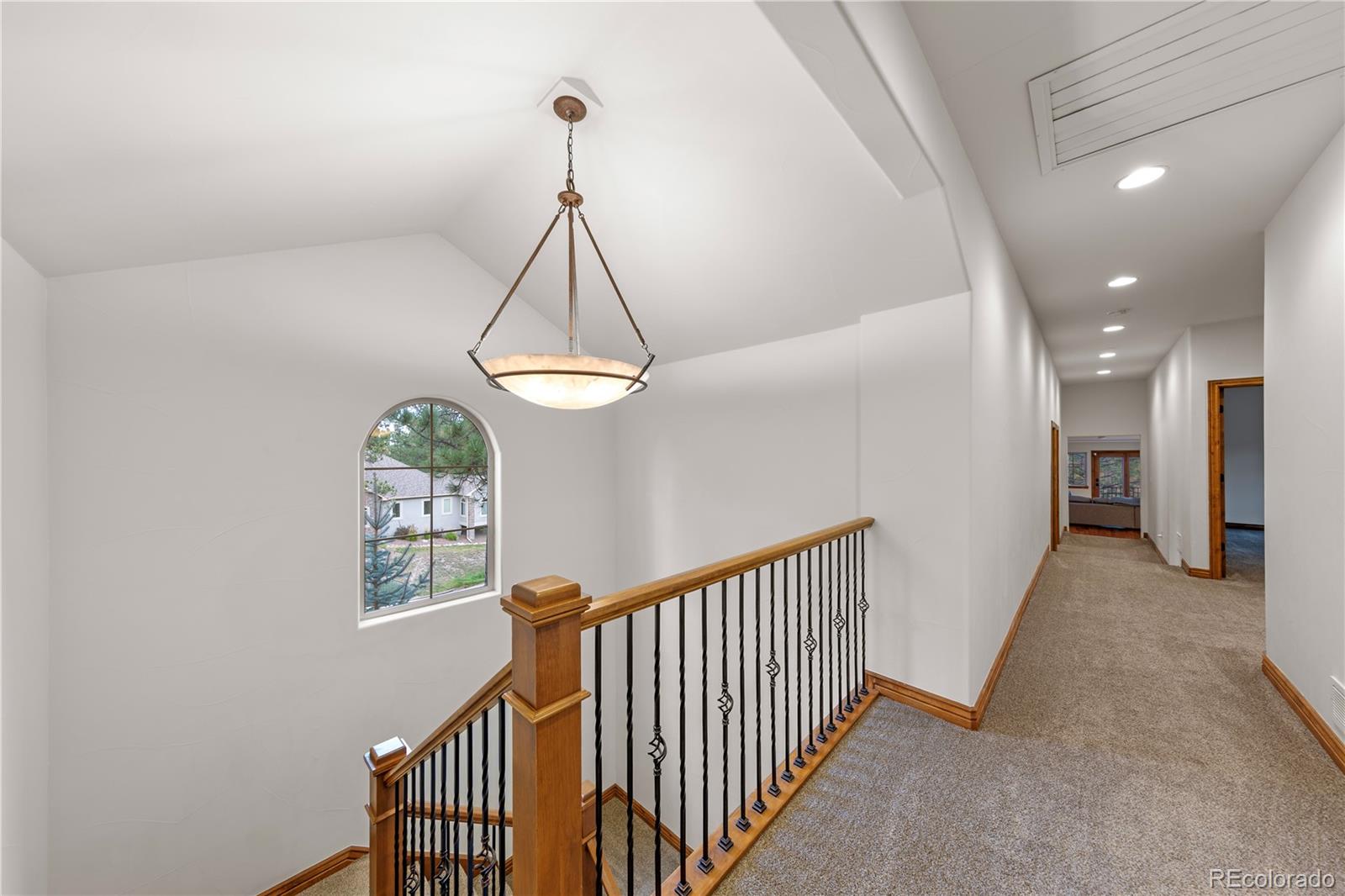 590 Cumberland Road Larkspur, CO 80118 - Photo 22 of 47 a view of a hallway with windows